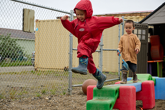 Children play outside at a pre-school in Alaska.