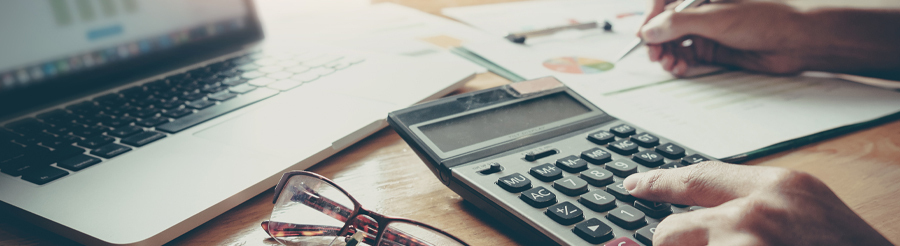 person using calculator to do math problems