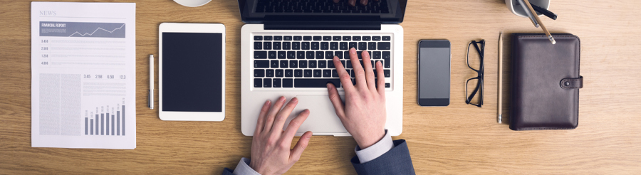 man typing on a laptop
