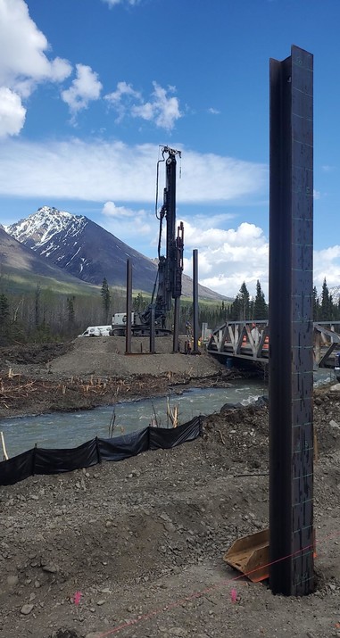 New piles for the Chokosna River Bridge on McCarthy Road with a mountain view in the background