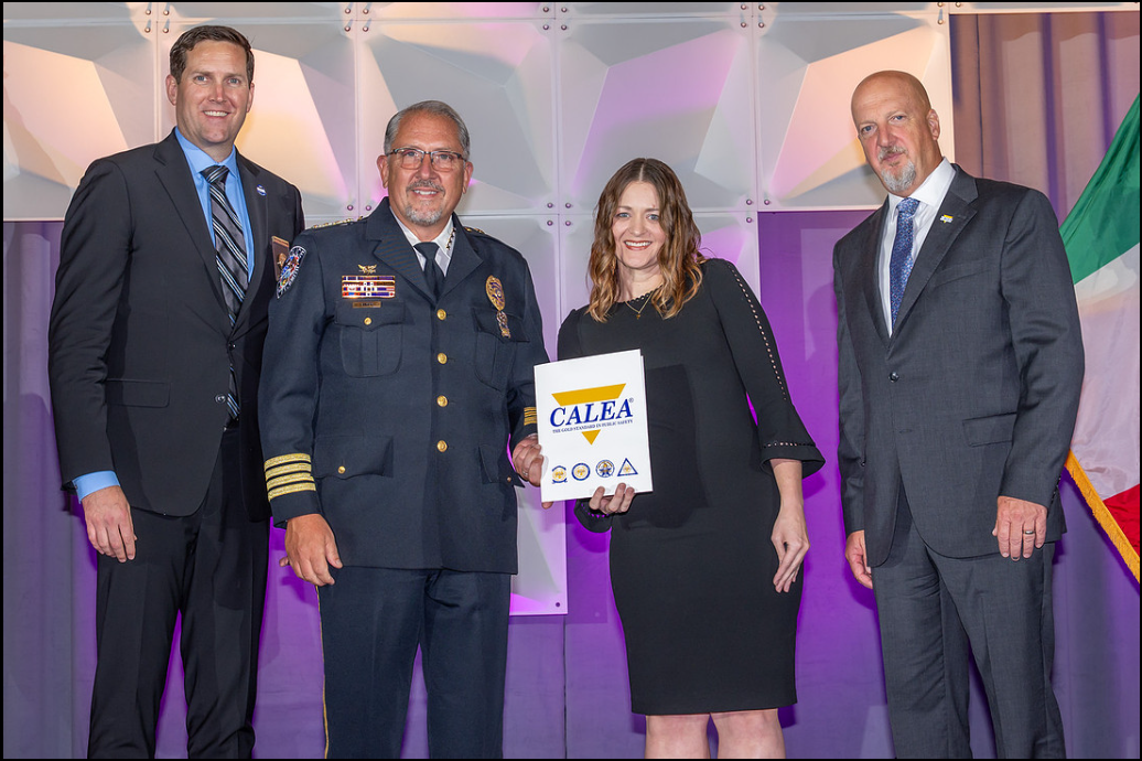 Pic of Chief Danny Baker and Officer Charity Abbott receiving award from CALEA Representatives at a conference in Omaha, Neb., on July 25, 2026. on 