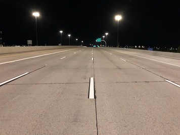 Lane lines on the Loop 101 Pima Freeway are marked with high-contrast white stripes on black borders for improved visibility.