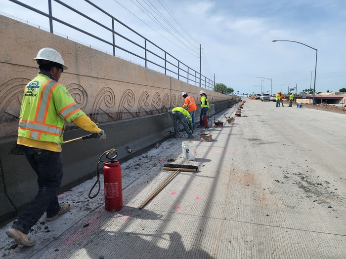 Crew working on a concrete barrier along northbound Loop 101.