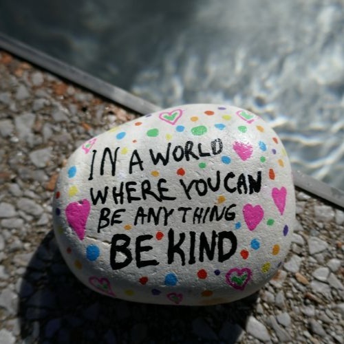 Be kind kindness rock on edge of pool close-up