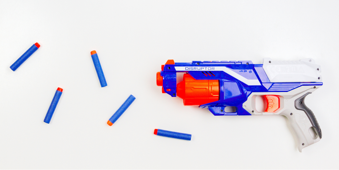 A Red and Blue NERF gun and darts on a white background