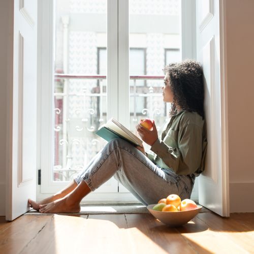Brazilian lady engrossed in a book reading in apartment