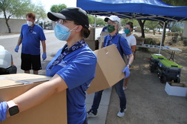 Volunteers in line with boxes of PPE