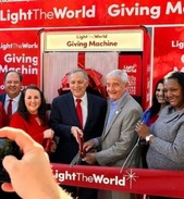 Light the world giving machine ribbon cutting