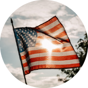 American Flag waving against blue sky with clouds