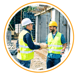 businessmen shaking hands at construction site