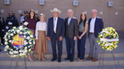 Councilmembers and Mayor standing between 2 memorial wreaths