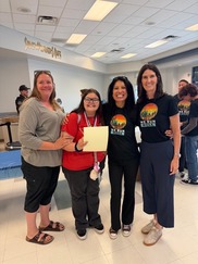 3 adults and 1 students posing with certificate