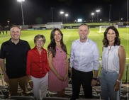 Councilmembers and City manager standing in front of soccer field