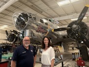 Woman and man in front of B-52 bomber 
