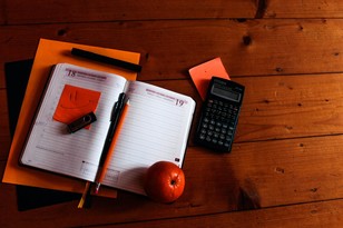 Calculator on a table with daily planner