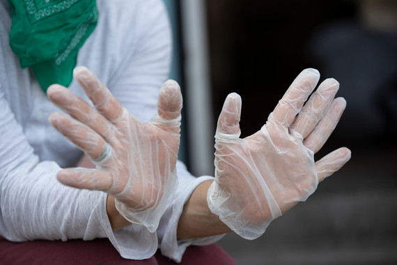 A pair of hands wearing rubber, food service gloves