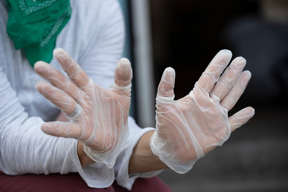 A pair of hands wearing rubber gloves for food service