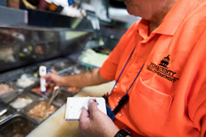 Health inspector checking prepped food in a restaurant