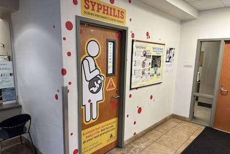 A door installation with information about syphilis
