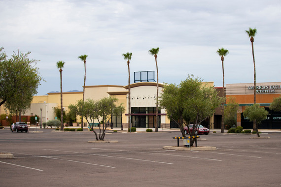 empty parking lot with retail building in the distance