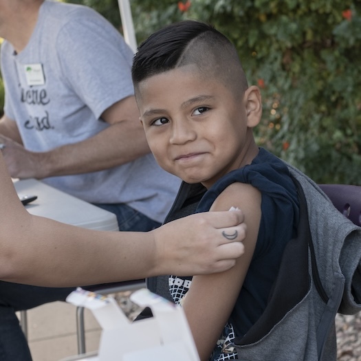 A child getting a vaccine from the Pima County Health Department