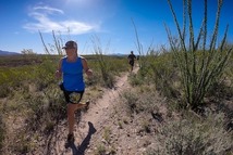 A woman running on a trail