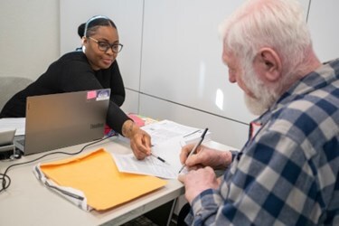 A volunteer helps a client file taxes