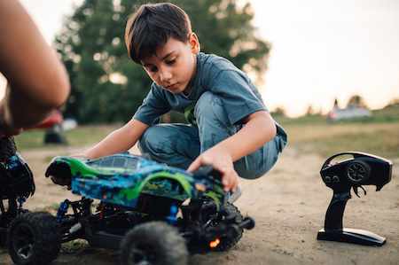 Boy playing with remote-controlled car