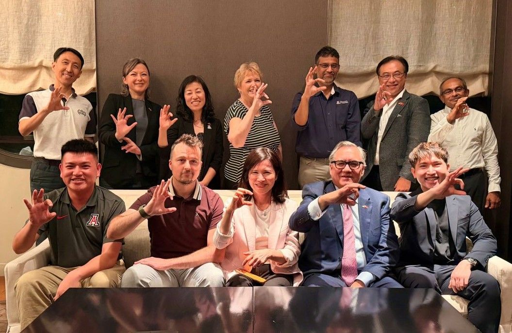 Taiwan & AZ people holding up Wildcat sign