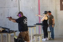 People aiming at targets at gun range