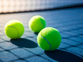 three tennis balls on a court