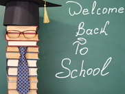 Welcome back poster with books stacked and welcome back message