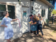 Two women seen cutting the ribbon to the door of the "Lab"rary