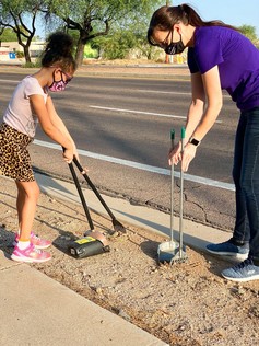 Councilwoman Lee and her daughter scooping up dog waste