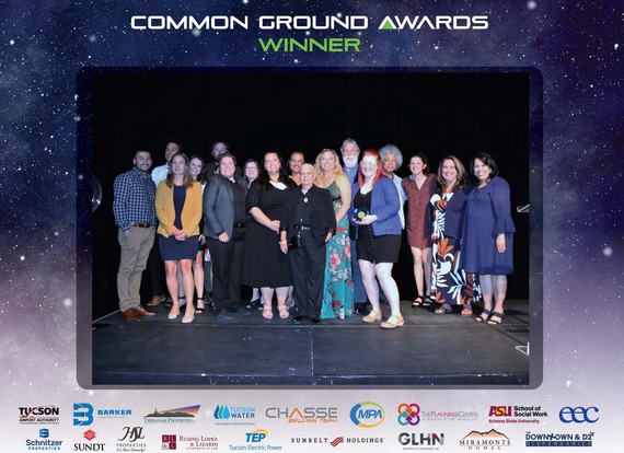 Members of Thrive in the 05 Smiling and holding the 2022 Common Ground Award