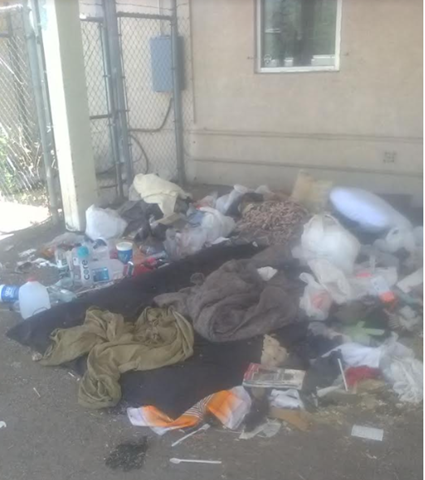 Picture showing unhoused man's belongings and place he stays