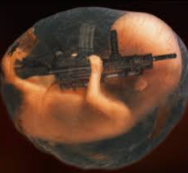 Picture of fetus in womb holding a semi automatic weapon