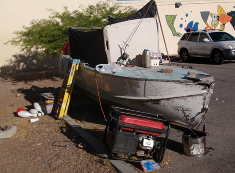 Picture of small boat filled with junk and garbage all around it