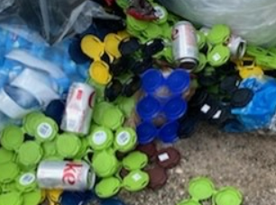 Picture shows pile of plastic waste with some cans