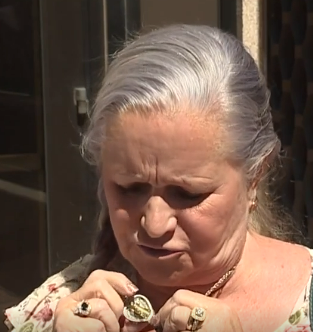 Picture shows Toni Solheid look down at the locket that contains Genna's remains