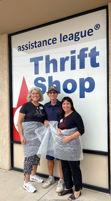 Picture shows the Assistance League board chair Monica, board member Monique and Steve K in bubble wrap together