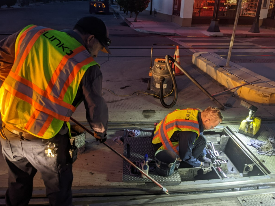 Picture shows Sun Link maintenance workers do the work on the streetcar line