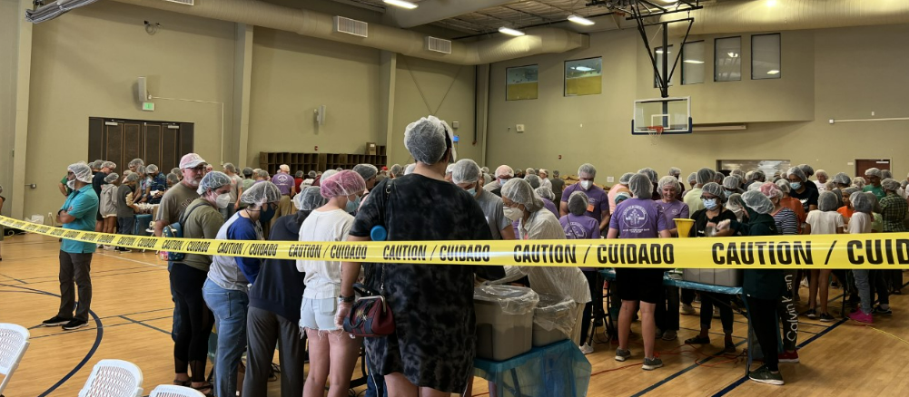 Picture shows volunteers work together to pack the food