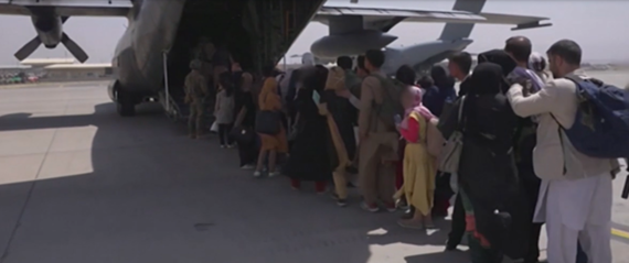 Picture shows people queue to get to the plane in Afghanistan
