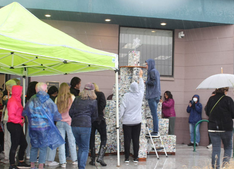 Picture shows several people attend the holiday tree event during the rain in front of ward 6 office