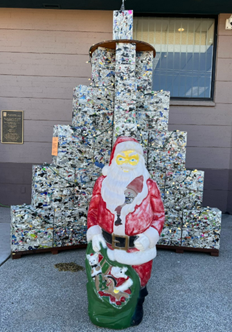 Picture shows plastic Santa stands in front of Holiday tree at Ward 6