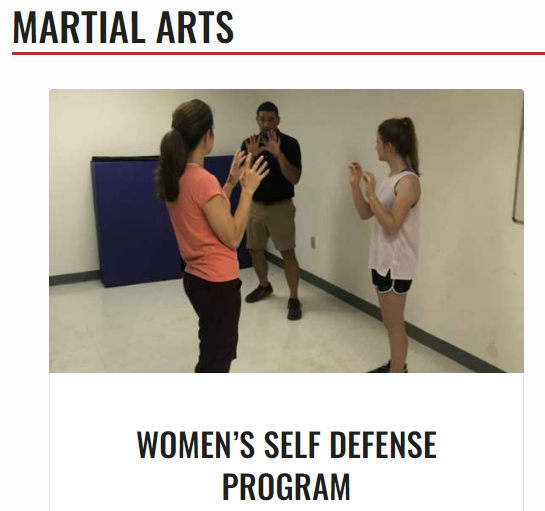 Picture shows 2 women participate in self defense program