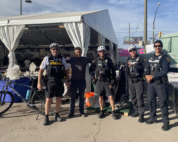 ODW officers standing in front of a vendor tent at the Gem Show
