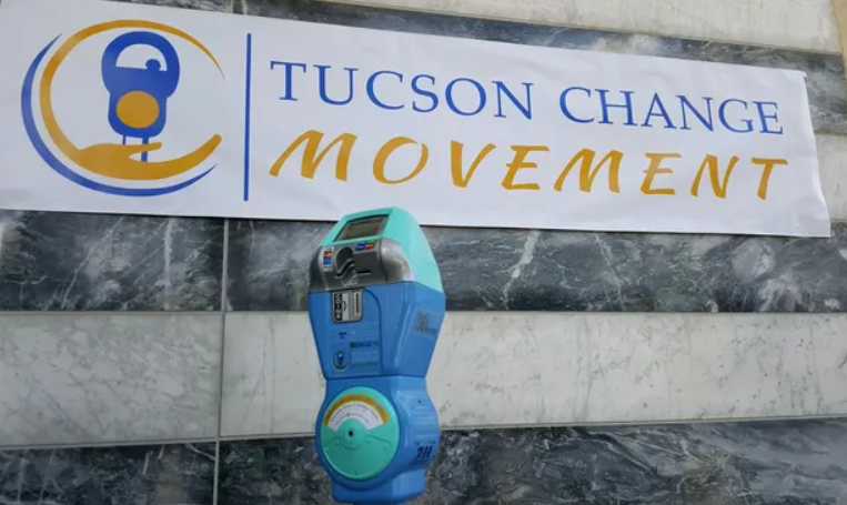 Picture shows a parking meter with banner says "Tucson Change Movement" as a background