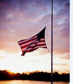 Picture shows the U.S. flag with sunset background